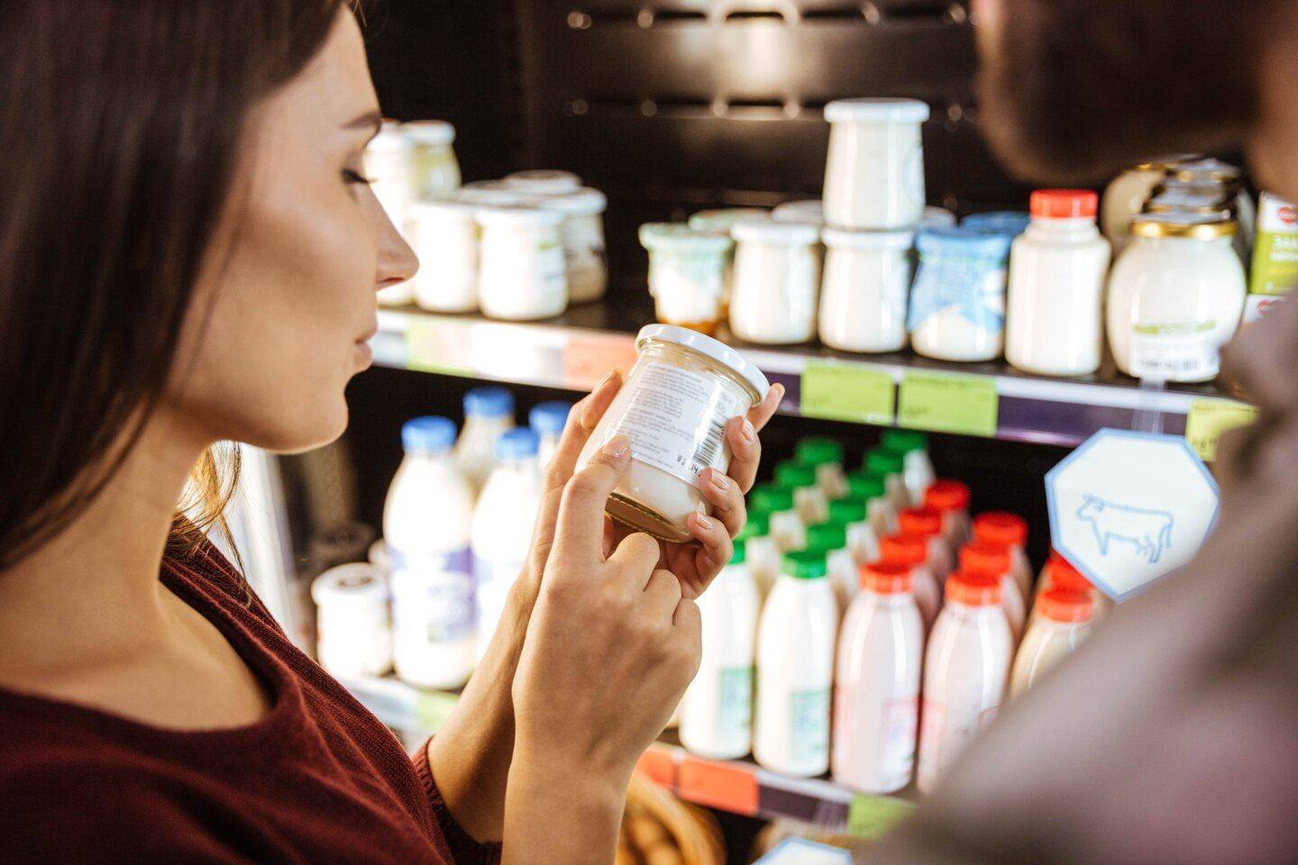 Woman in a shop with a jar of mayo