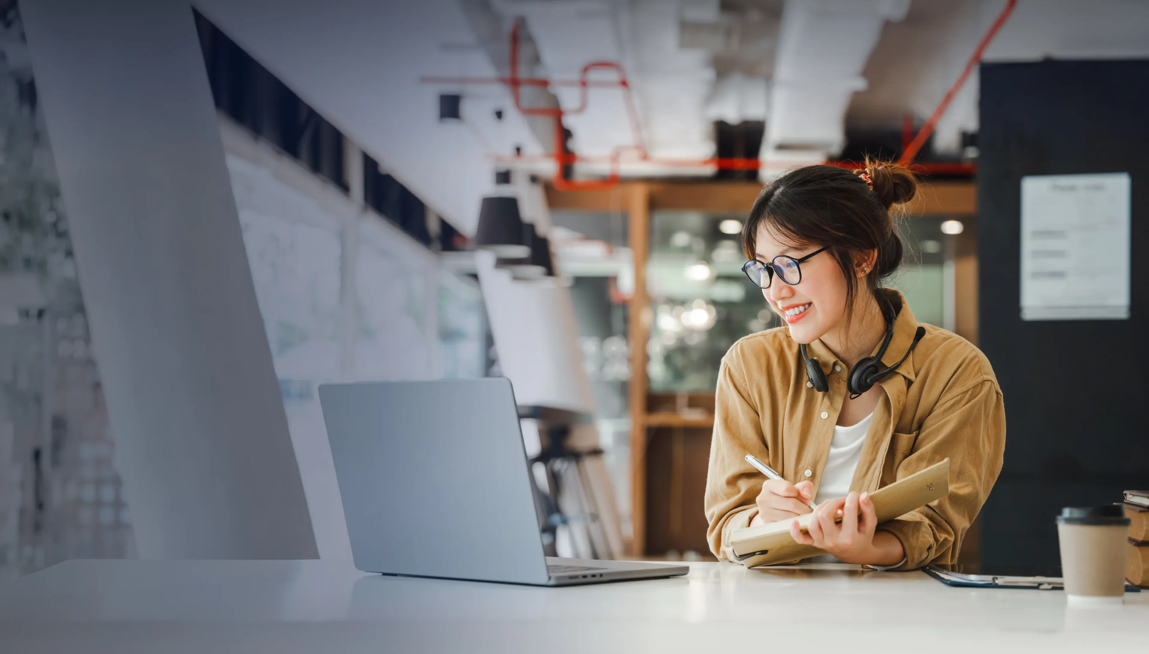 Happy female student working on her research project in an online session