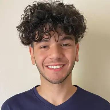 photo of a student with curly brown hair